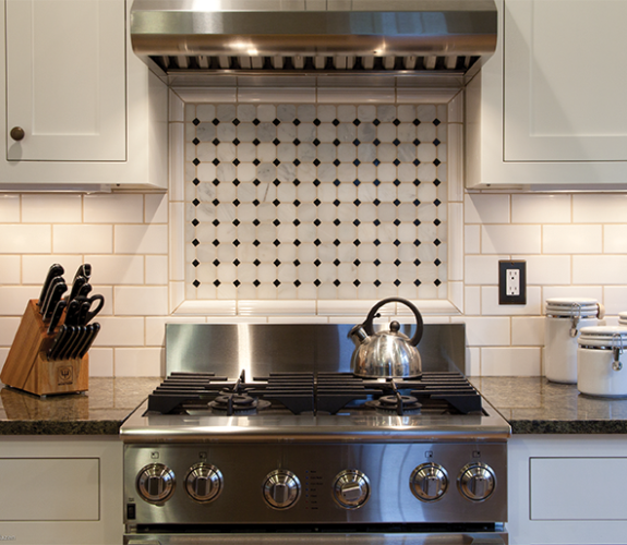kitchen stove with tile backsplash